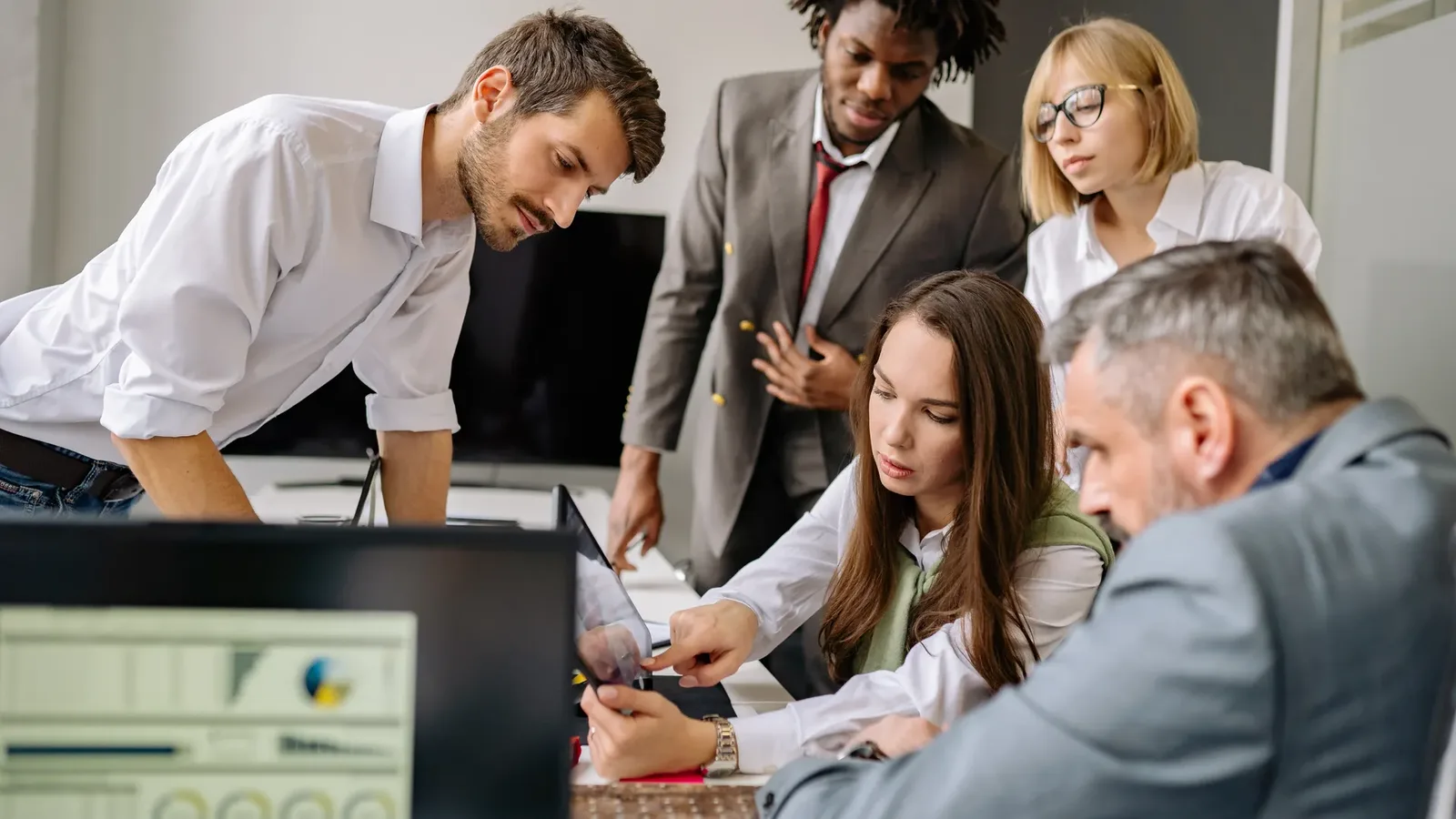 Business team reviewing AI automation options on screens in a modern office
