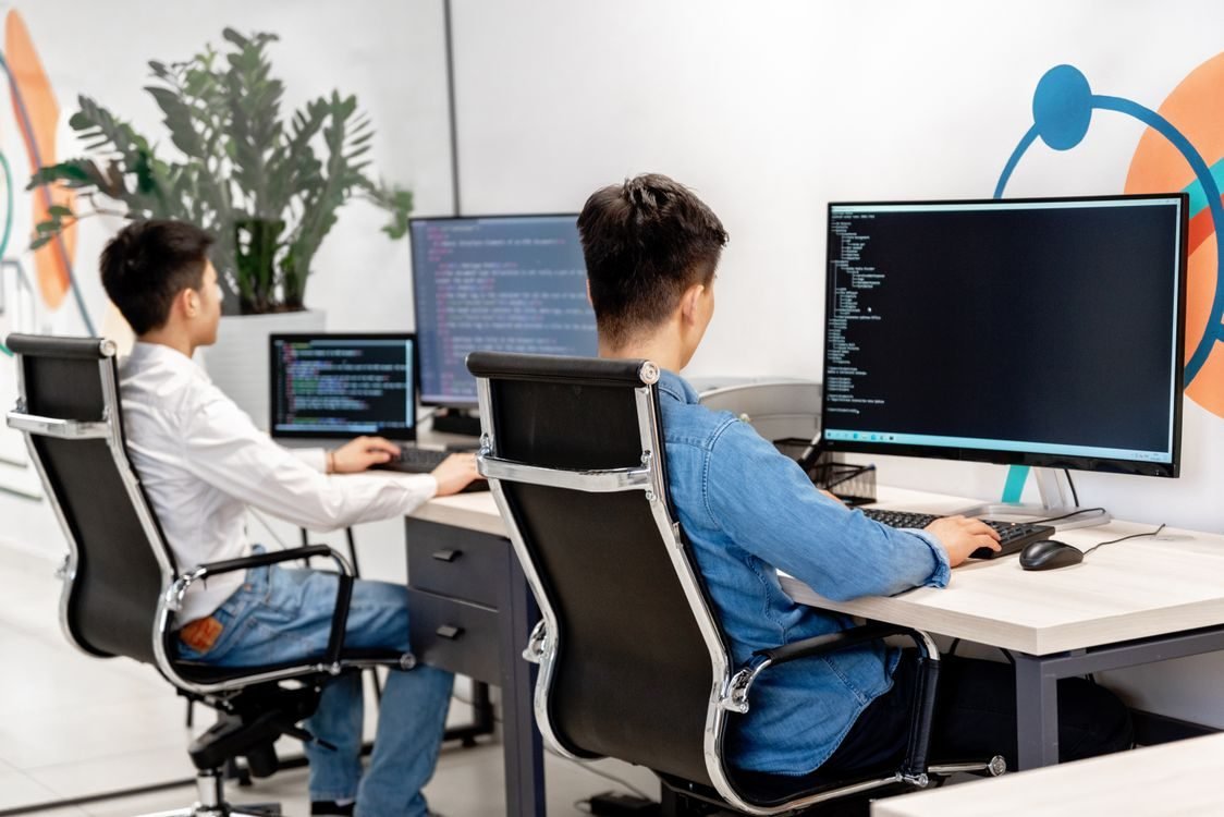 Engineers reviewing workflow data on a laptop during an AI readiness audit
